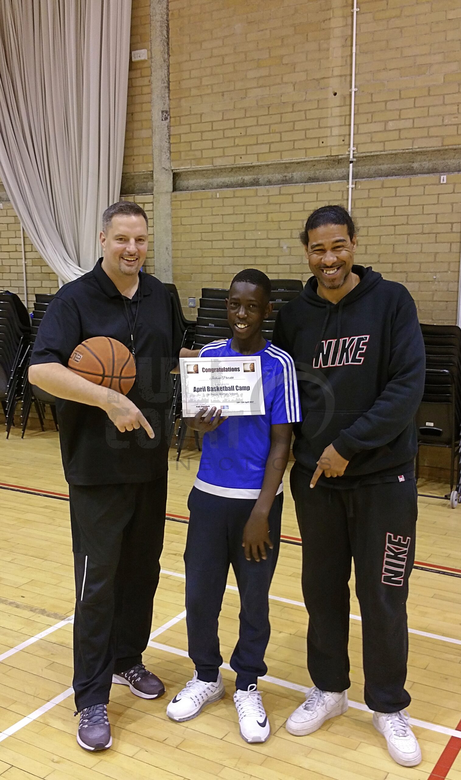 Coach Leon with a camper of the week and fellow coach