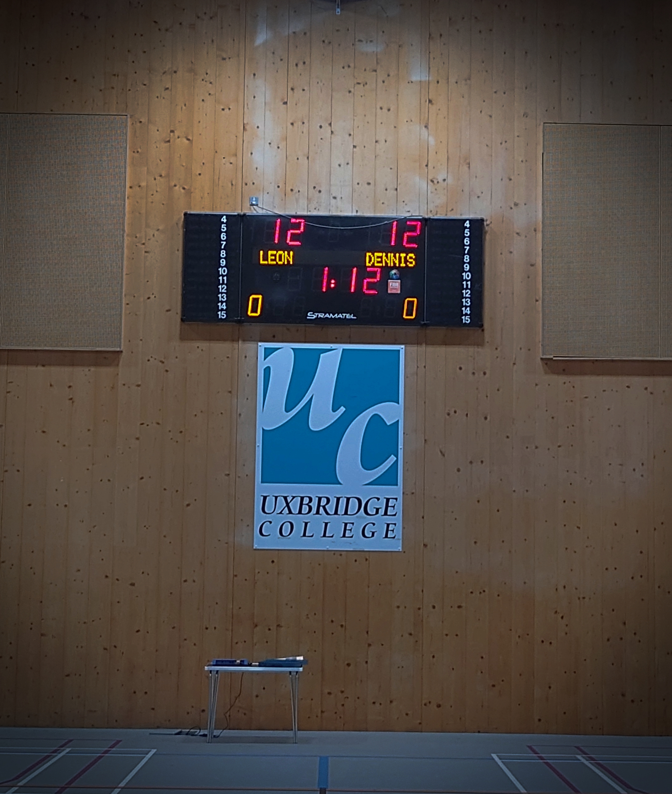 Memorial scoreboard showing Leon Dennis's name at Uxbridge College