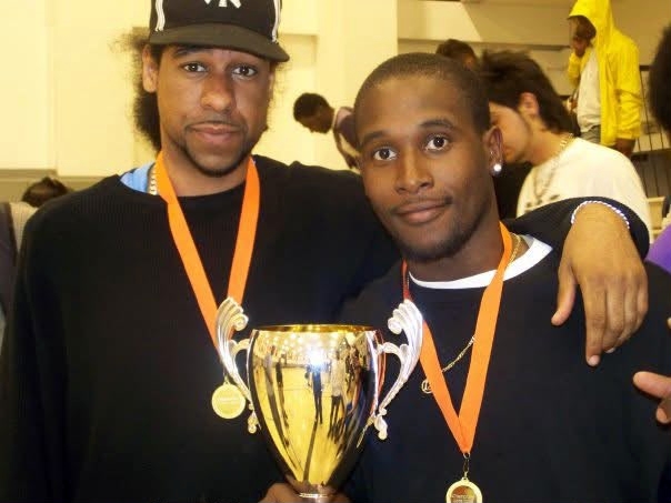 Coach Leon and a Uxbridge Emperors teammate with a basketball trophy