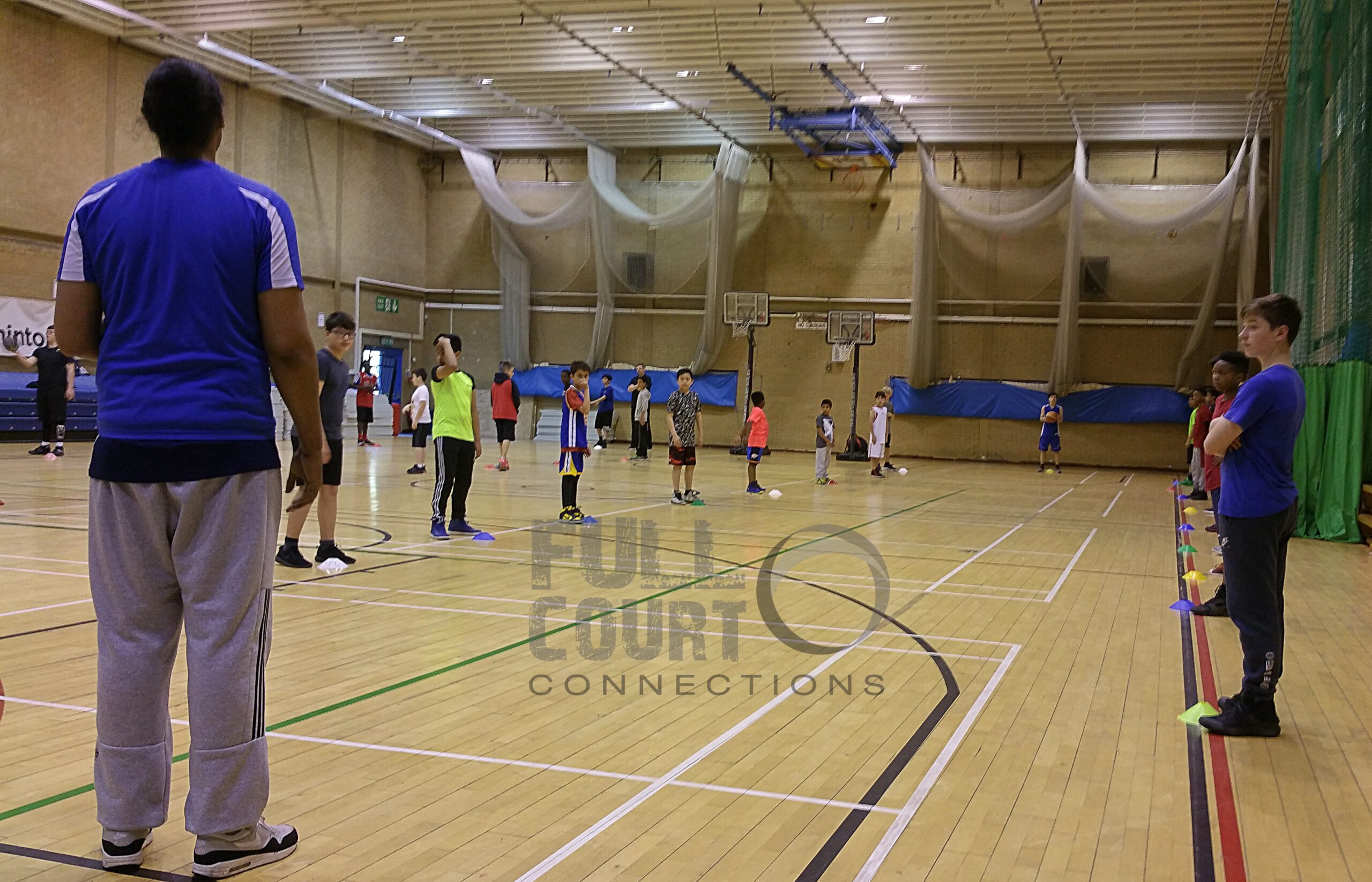 Coach Leon coaching young basketball players at Brunel