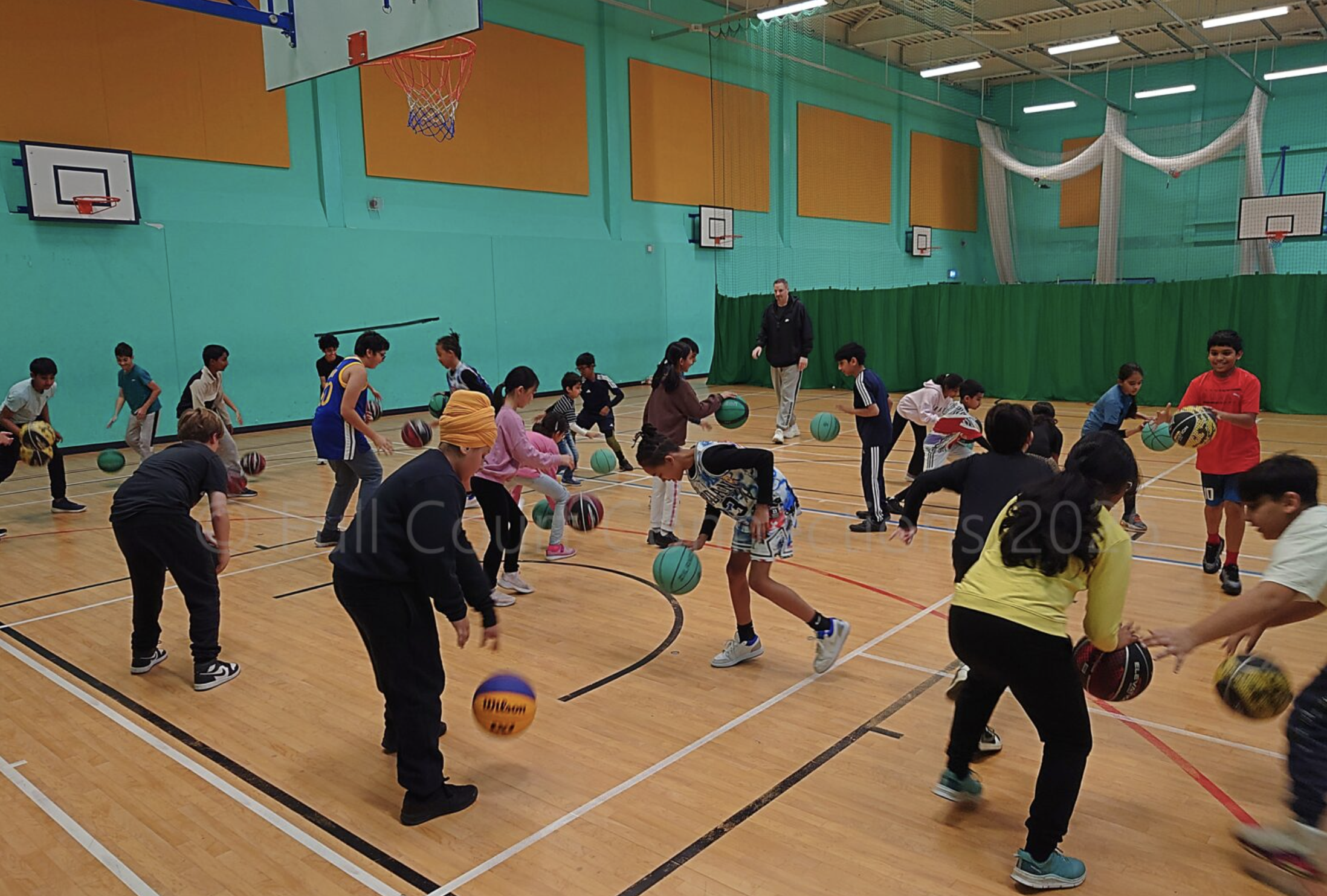 Young players practising dribbling at a Full Court Connections community basketball session